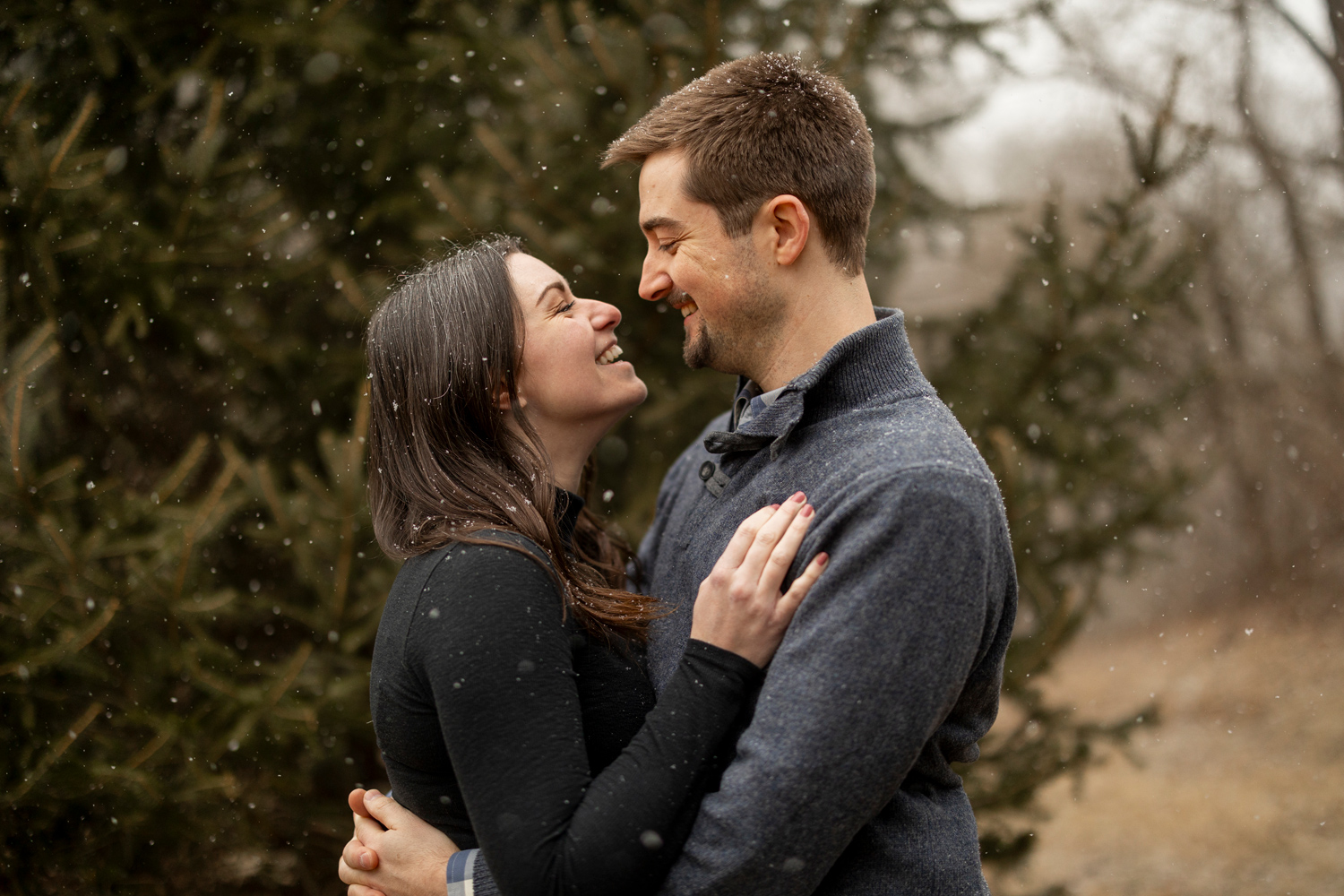 engaged couple happy together in a late autumn flurry
